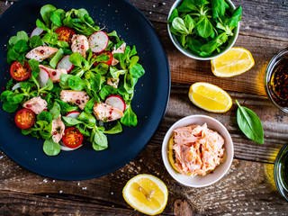 Salmon salad - roasted salmon and vegetables on wooden background
