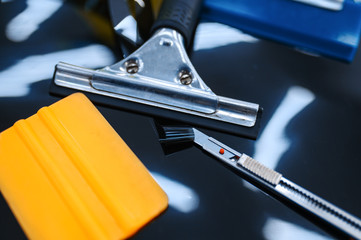 Tools for car tinting closeup, vehicle tuning - obrazy, fototapety, plakaty