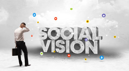 Young businessman standing in front of SOCIAL VISION inscription, social media concept