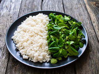 White rice and vegetables on wooden table