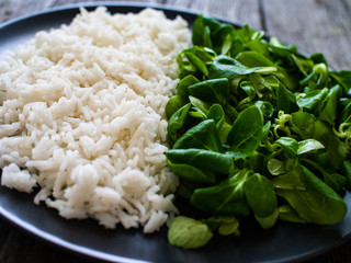 White rice and vegetables on wooden table