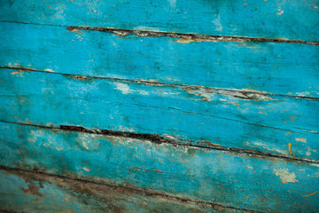 Vintage blue wood background texture with knots and nail holes. Old painted wood wall. Blue abstract background. Vintage wooden dark horizontal boards. Front view with copy space