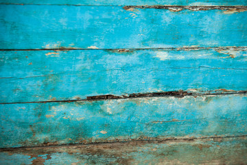Fototapeta na wymiar Vintage blue wood background texture with knots and nail holes. Old painted wood wall. Blue abstract background. Vintage wooden dark horizontal boards. Front view with copy space