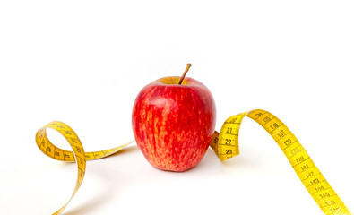 Red Apple with yellow measuring tape isolated on a white background.