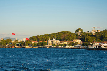 Fototapeta premium The Green Crescent building on the Sultanahmet waterfront with Topkapi Palace on the hill in the background