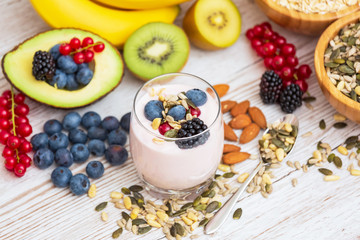 Obraz na płótnie Canvas Fruits and Breakfast with Whole grains and nuts, yogurt mix with Cherry , banana, avocado in the wooden table. Breakfast for Health and Diet concept