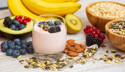 Fruits and Breakfast with Whole grains and nuts, yogurt mix with Cherry , banana, avocado in the wooden table. Breakfast for Health and Diet concept