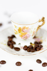 Cup of coffee or porcelain tea on white background with coffee beans