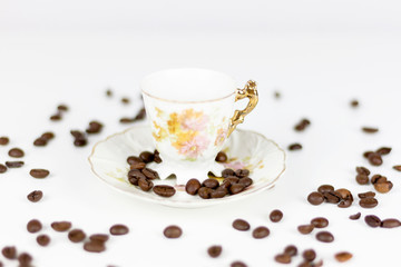 Cup of coffee or porcelain tea on white background with coffee beans