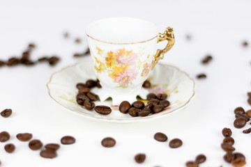 Cup of coffee or porcelain tea on white background with coffee beans