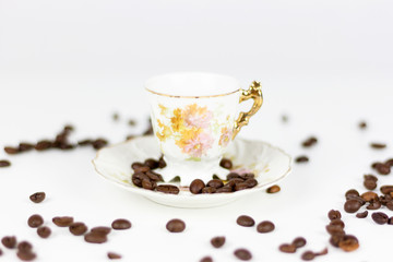Cup of coffee or porcelain tea on white background with coffee beans