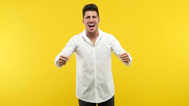 Young handsome man screaming angry, expression of madness and mental instability, madness concept