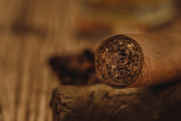 Fototapeta na wymiar Pile of new cigars close up on wooden table