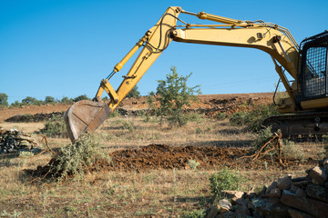Crawler excavator working at the construction site. Construction machinery for excavating, loading, lifting and hauling of cargo on job sites