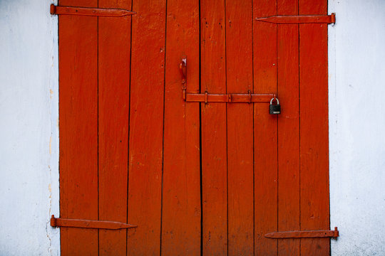 Red beautiful textured wooden old gates. Old wooden textured big doors. 