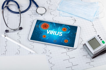 Close-up view of a tablet pc with VIRUS inscription, microbiology concept