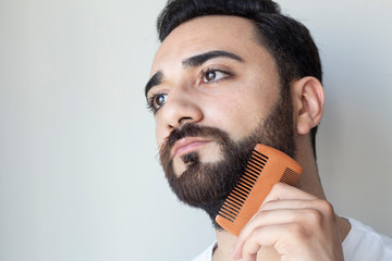 Bearded man comb his beard