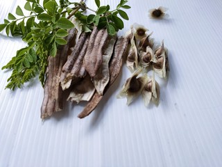 The horseradish is dried on a white surface.