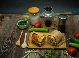 Snack at break time. Famous Vietnamese food is Banh mi thit and black coffee, popular street food from bread stuffed with raw material: pork, ham, pate, egg and fresh herbs.Typical Vietnamese sandwich