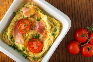 Backed omelette with prosciutto, cheese and tomatoes