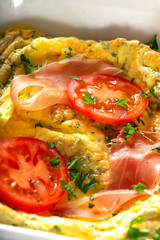 Backed omelette with prosciutto, cheese and tomatoes
