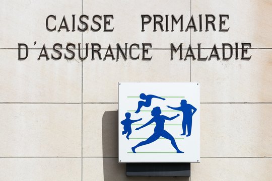 Vienne, France - June 7, 2020: Social security sign on a wall. Illness branch called Assurance Maladie is one of the four branches with retirement, family, work accident in France