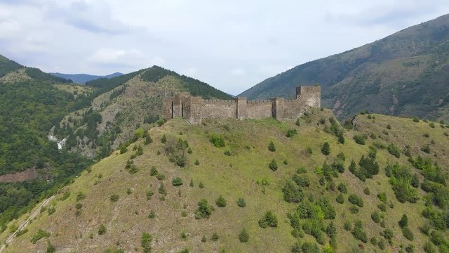 Aerial view of Maglic medieval fortress. The castle is located a top a hill around which the Ibar river in Serbia. The fortress consist of seven towers and one dungeon tower connected with walls