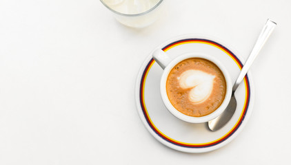 Cappuccino coffe cup with latte art heart. on a gray background. top view copy space