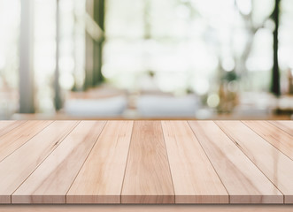 Empty wooden table with blurred cafe and coffee shop interior background