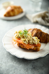 Croissant with smoked salmon and scrambled eggs