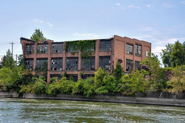 Fototapeta na wymiar Old abandoned factory on the shore of the Cayuga-Seneca Canal