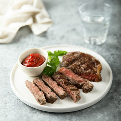 Grilled beef steak with tomato sauce