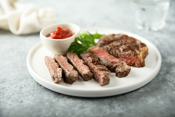 Grilled beef steak with tomato sauce