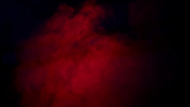 Soft Red Fog in Slow Motion on Dark Backdrop. Realistic Atmospheric Red Smoke on Black Background. Red Fume Slowly Floating Rises Up. Abstract Haze Cloud. Smoke Stream Effect