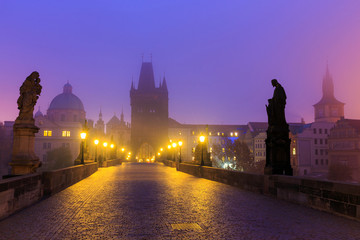 Twilight dawn at the famous medieval Charles Bridge that crosses the Vltava river in Prague (Praha), Czech republic.