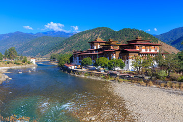 Fototapeta na wymiar The Punakha Dzong, also known as Pungtang Dechen Photrang Dzong (meaning the palace of great happiness or bliss) is the administrative center of Punakha dzongkhag in Punakha, Bhutan.