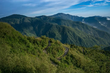 Two color merges of a huge Himalayan landscape and a zigzag road in the visible mountain lap