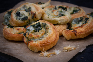 Spinach cheese puff pastry rolls on brown paper