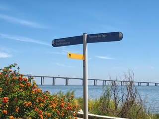 Walking the footpath Passeio do Tejo along Tagus river in Lisbon at the Expo park - Vasco da Gama bridge