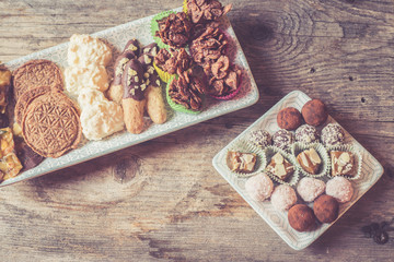 Traditional homemade Christmas cookies: Variety of sweet European cookies on rustic wooden desk, powdered sugar.