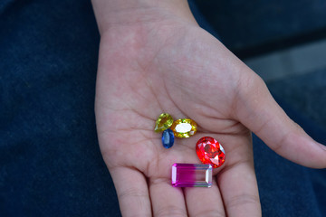 
A large red gemstone is on hand for making jewelry.