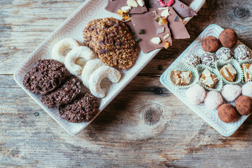 Traditional homemade Christmas cookies: Variety of sweet European cookies on rustic wooden desk, powdered sugar.