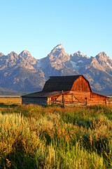Obraz premium Sunrise over Mormon Row in Grand Teton National Park with the mountains in the background in Wyoming, United States
