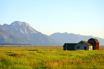 Sunrise over Mormon Row in Grand Teton National Park with the mountains in the background in Wyoming, United States