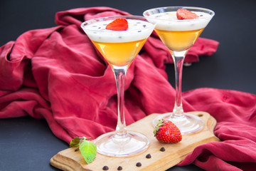 Italian dessert panna cotta with strawberries and lemon