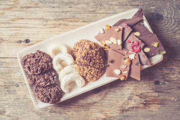 Traditional homemade Christmas cookies: Variety of sweet European cookies on rustic wooden desk, powdered sugar.