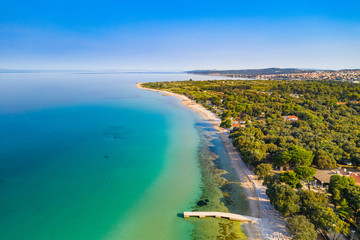 Croatia, island of Pag, beautiful touristic resorts, long beaches under pine trees, Adriatic Sea on sunny summer day. Aerial drone view.