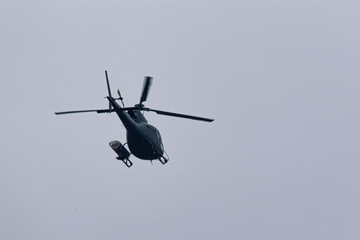 Small helicopter with three blades  in the air