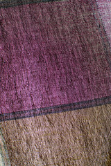 Closeup of fabric in different colors and seams.