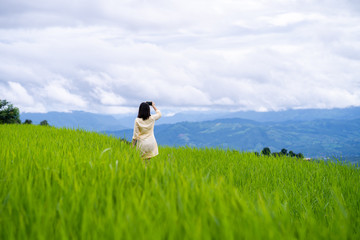 Young woman taking selfie at rice terrace field. 